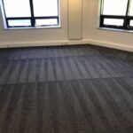 This is a photo of a grey office carpet that has just been professionally steam cleaned works carried out by Rickmansworth Carpet Cleaning