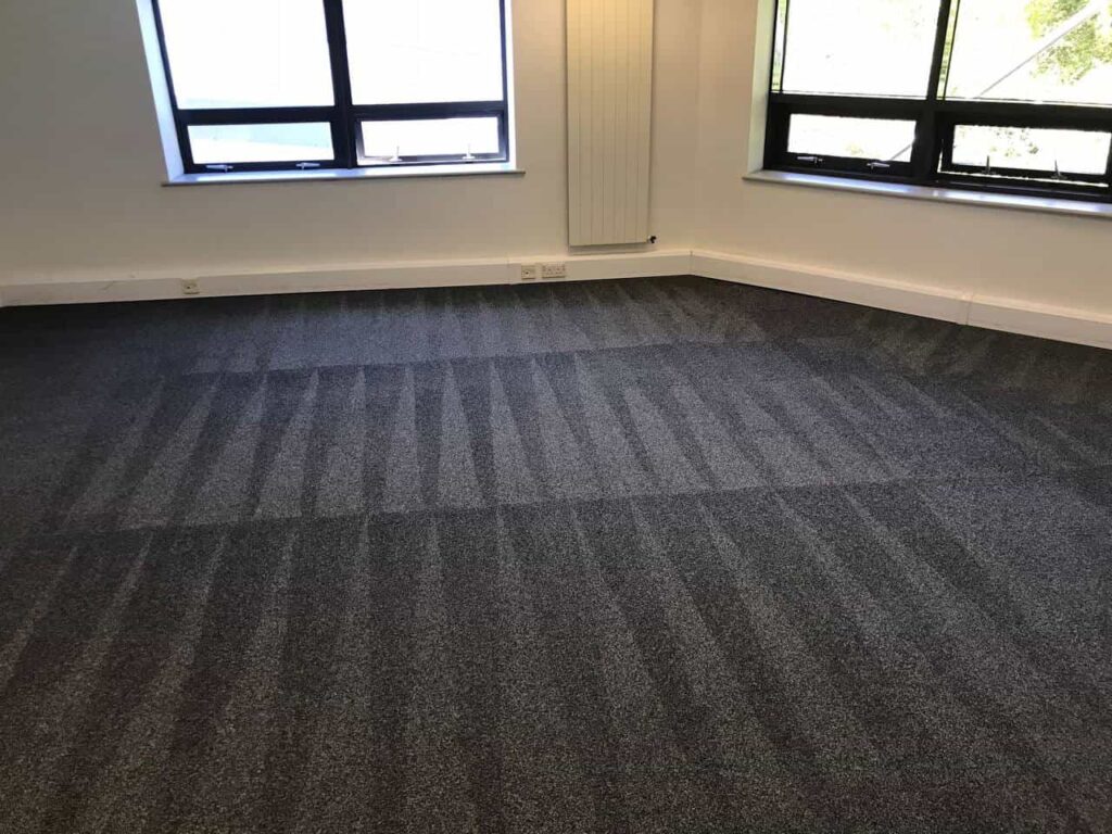 This is a photo of a grey office carpet that has just been professionally steam cleaned works carried out by Rickmansworth Carpet Cleaning