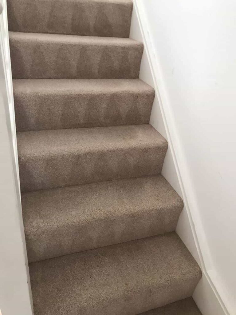 This is an after photo of a staircase with a beige carpet that has been cleaned works carried out by Rickmansworth Carpet Cleaning