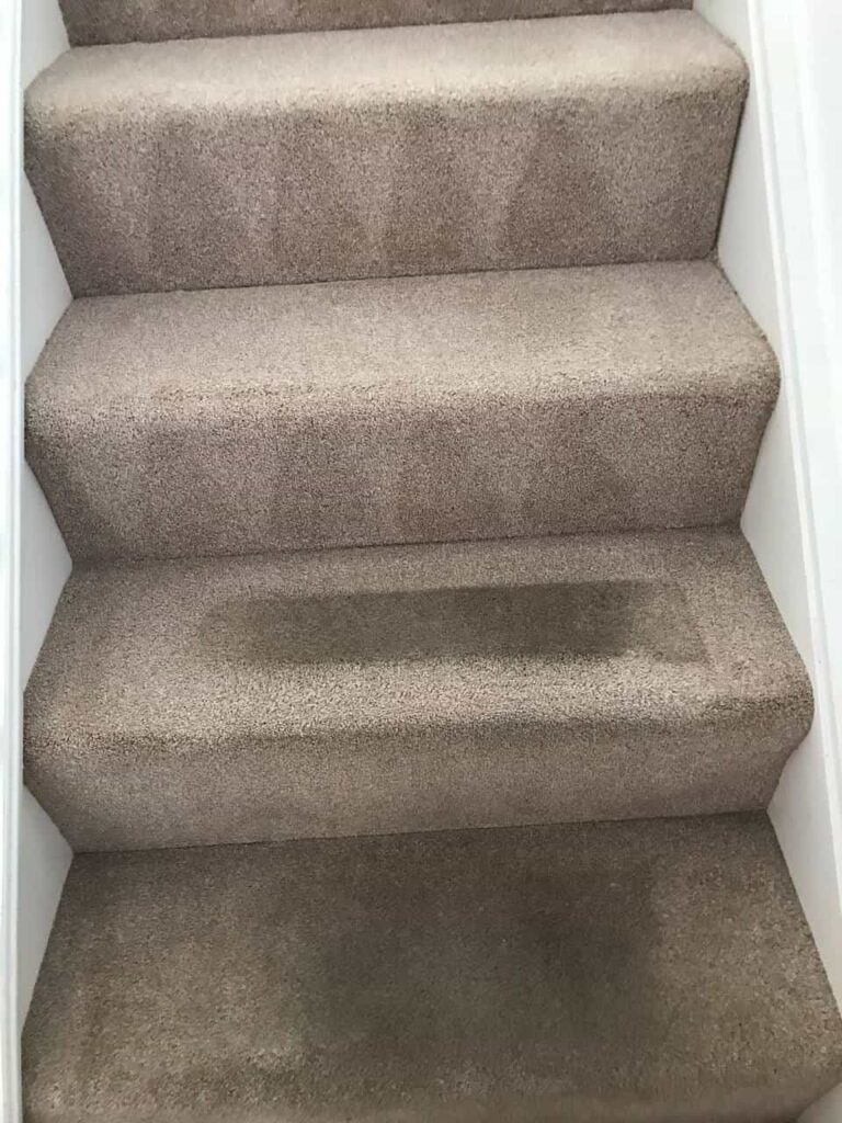 this is a photo of a staircase with beige carpets that is in the process of being cleaned works carried out by Rickmansworth Carpet Cleaning